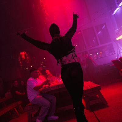 Dancer performing under pink stage lighting