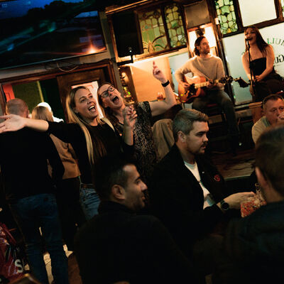 Friends singing along to the live music