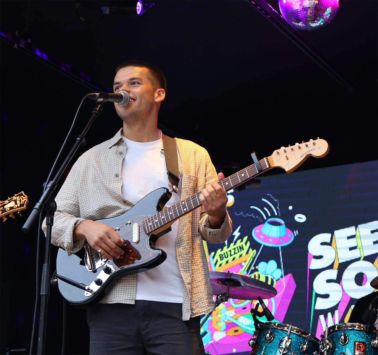 A male guitarist performing at Seed Sounds Weekender