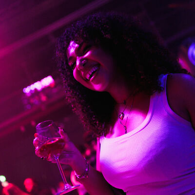 Woman smiling while holding a glass of wine